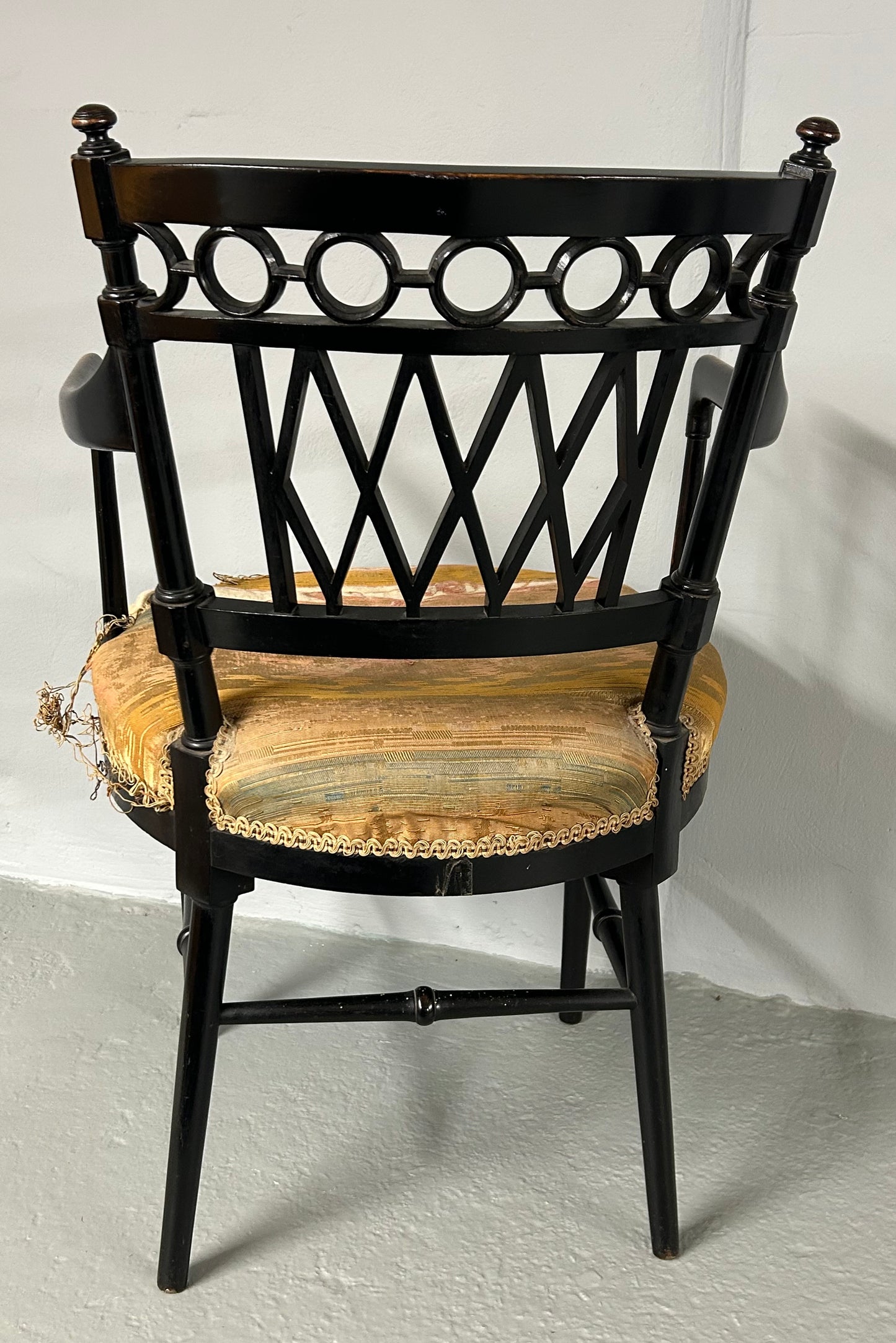 Collier and Plucknett ebonised aesthetic movement armchair.