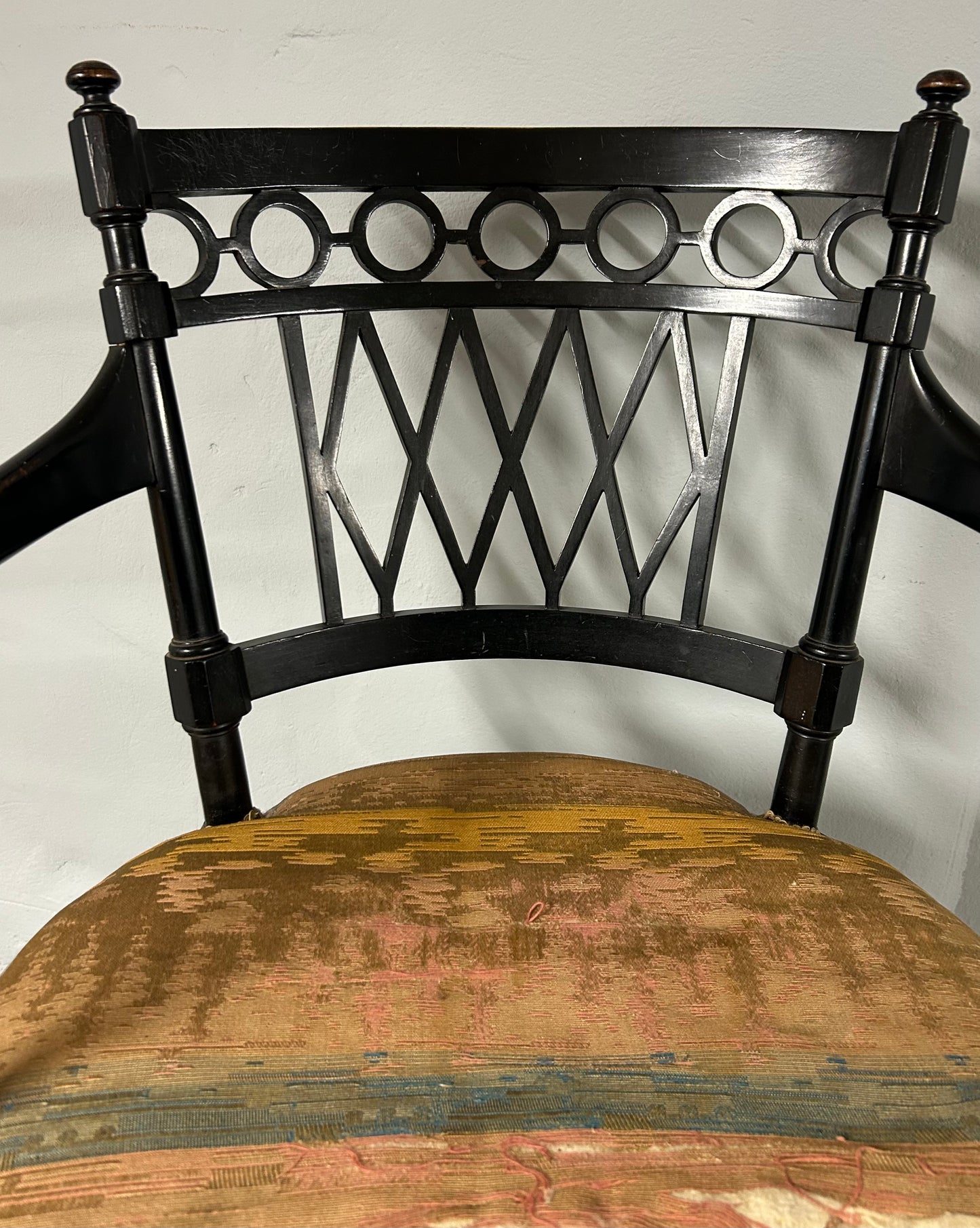 Collier and Plucknett ebonised aesthetic movement armchair.