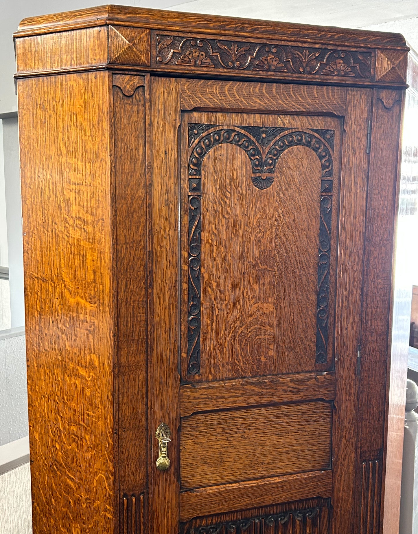 Solid oak 1920s hall robe with linen fold door