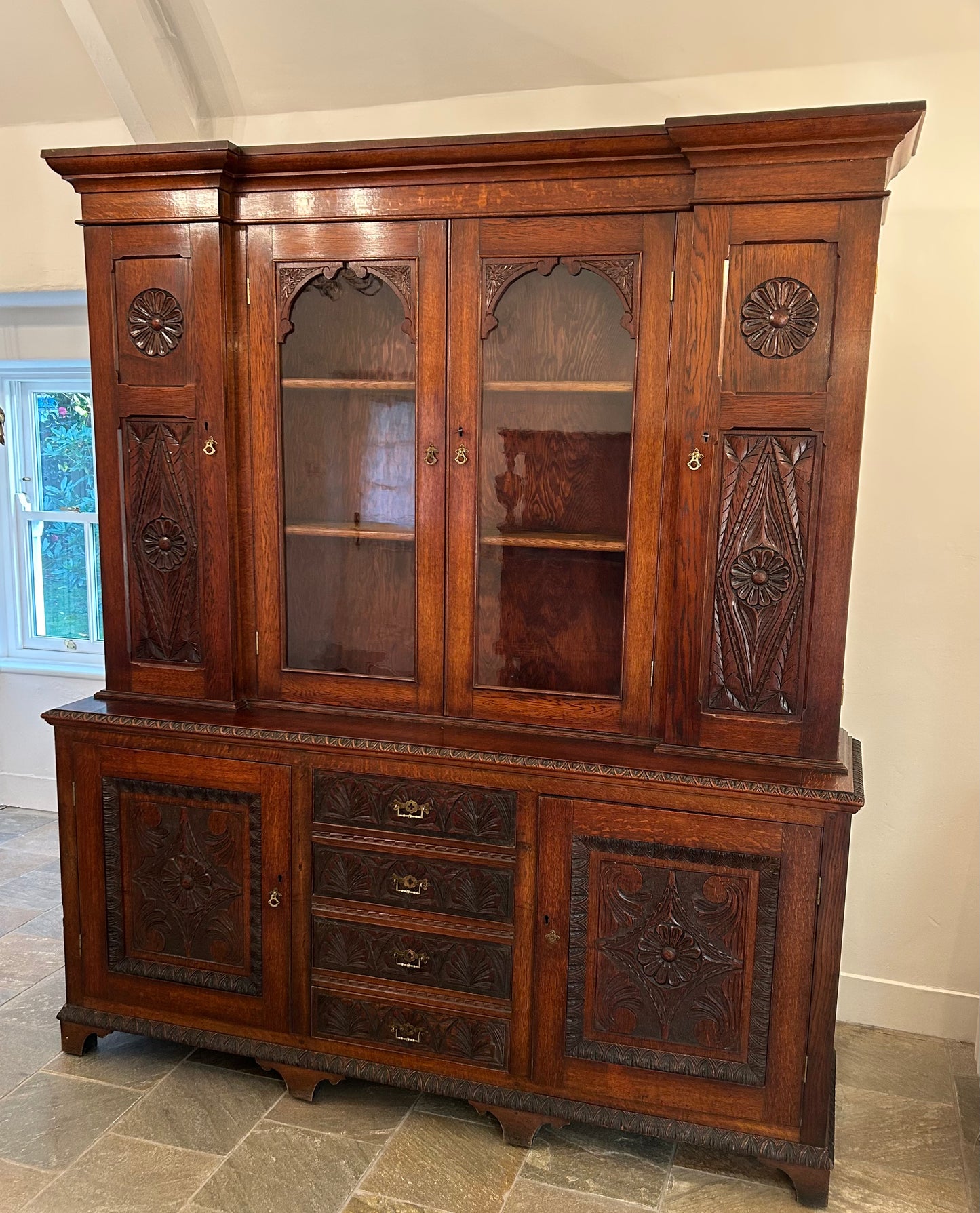 Large oak bookcase on carved cupboard base