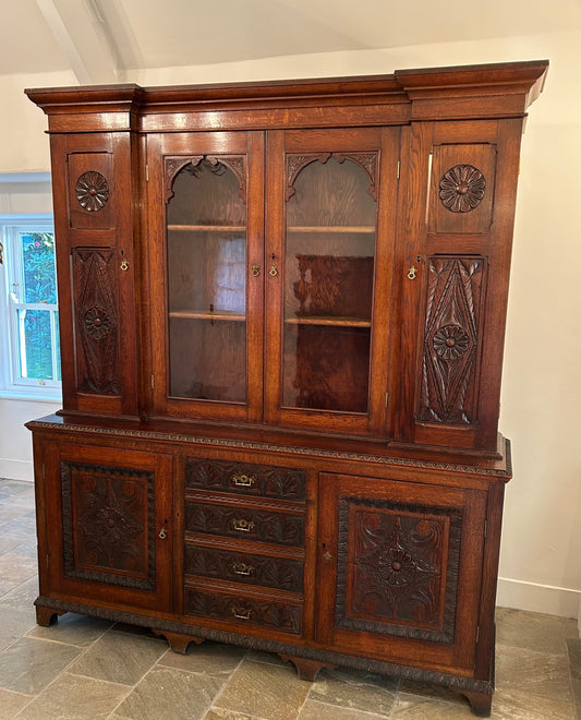 Large oak bookcase on carved cupboard base