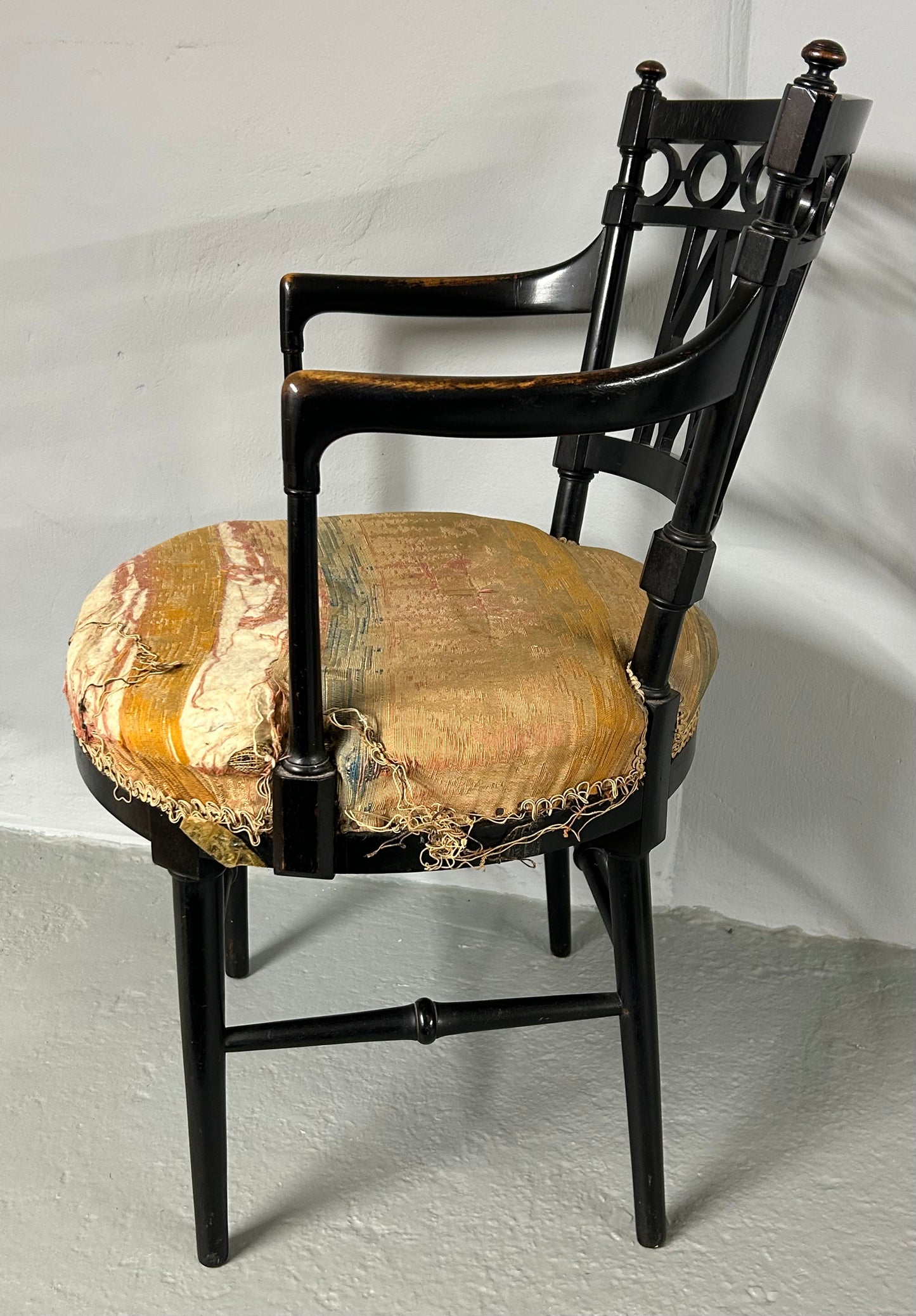 Collier and Plucknett ebonised aesthetic movement armchair.