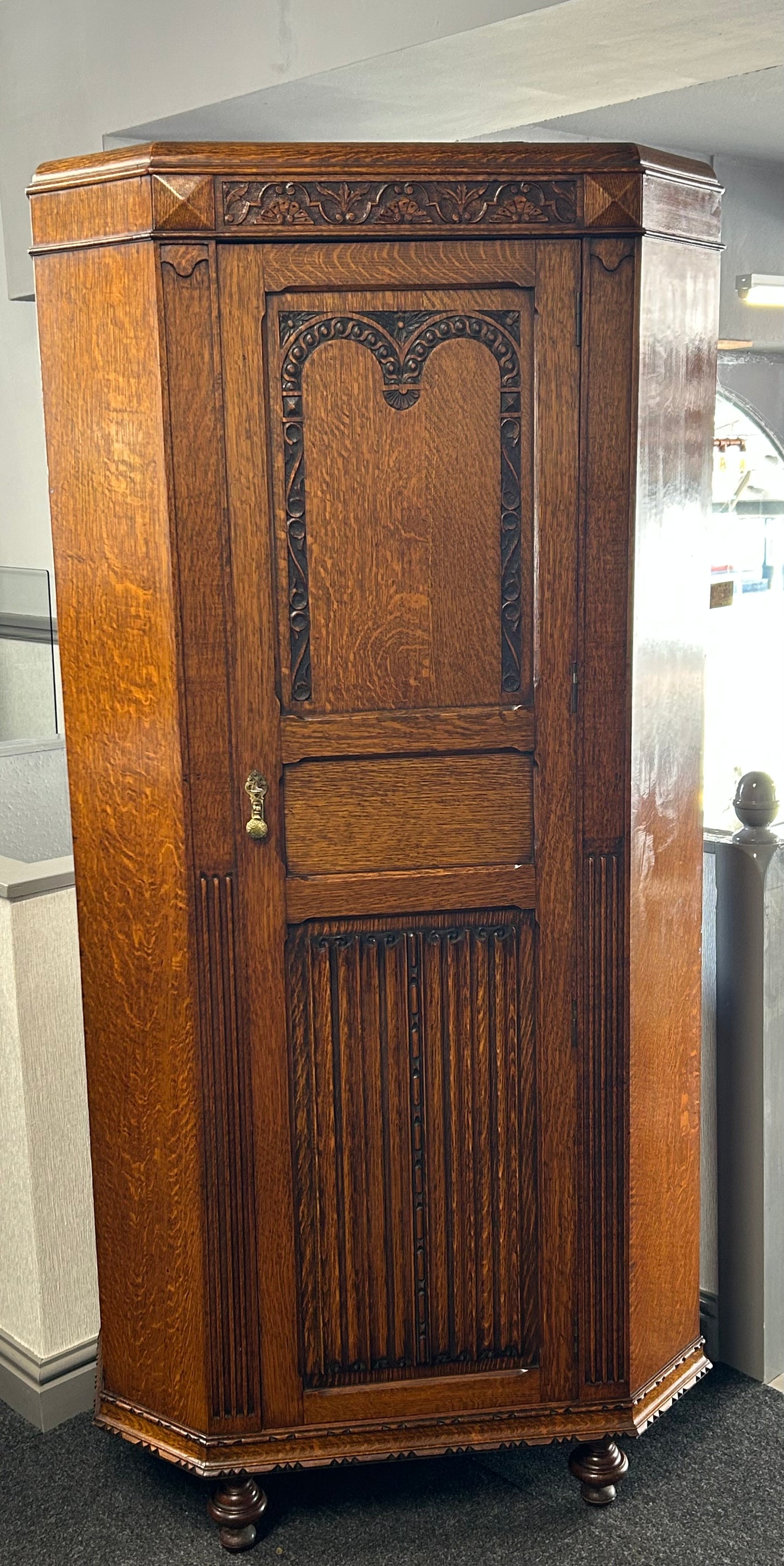 Solid oak 1920s hall robe with linen fold door