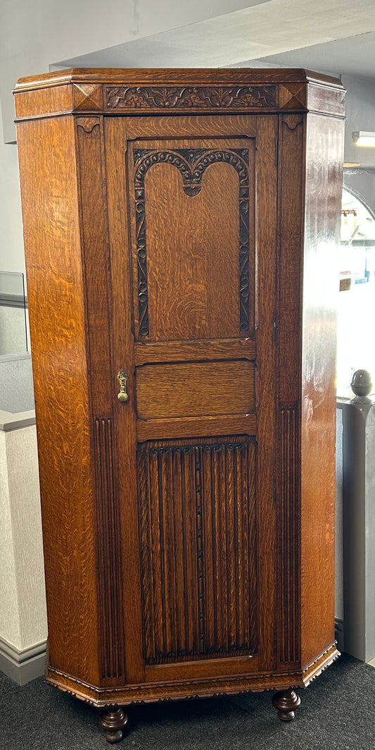 Solid oak 1920s hall robe with linen fold door