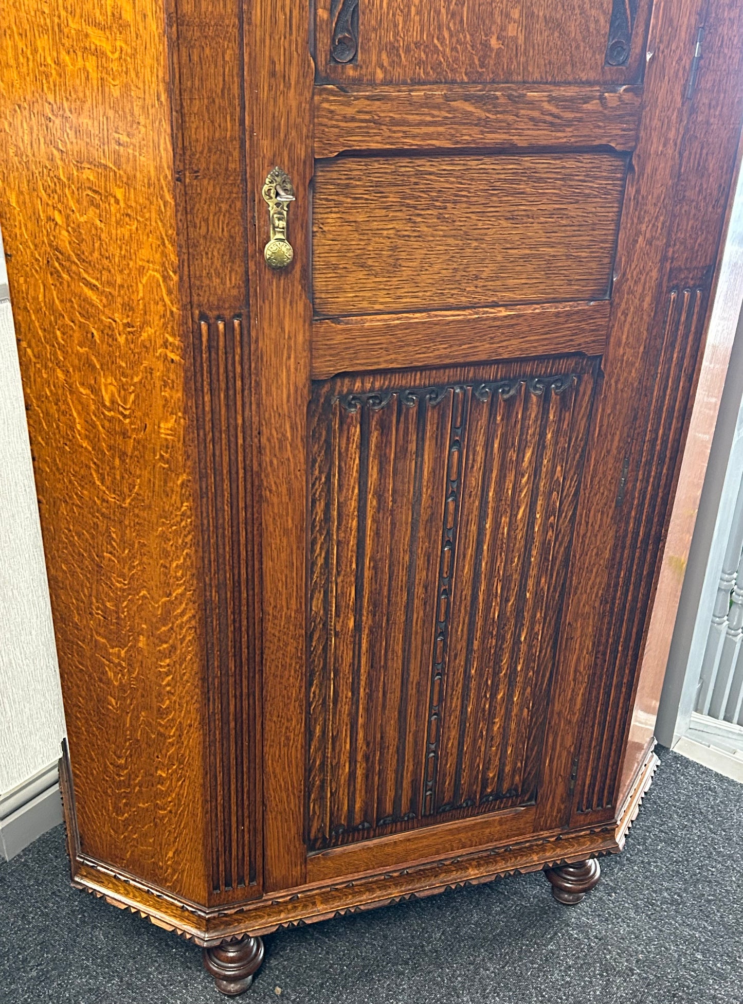 Solid oak 1920s hall robe with linen fold door
