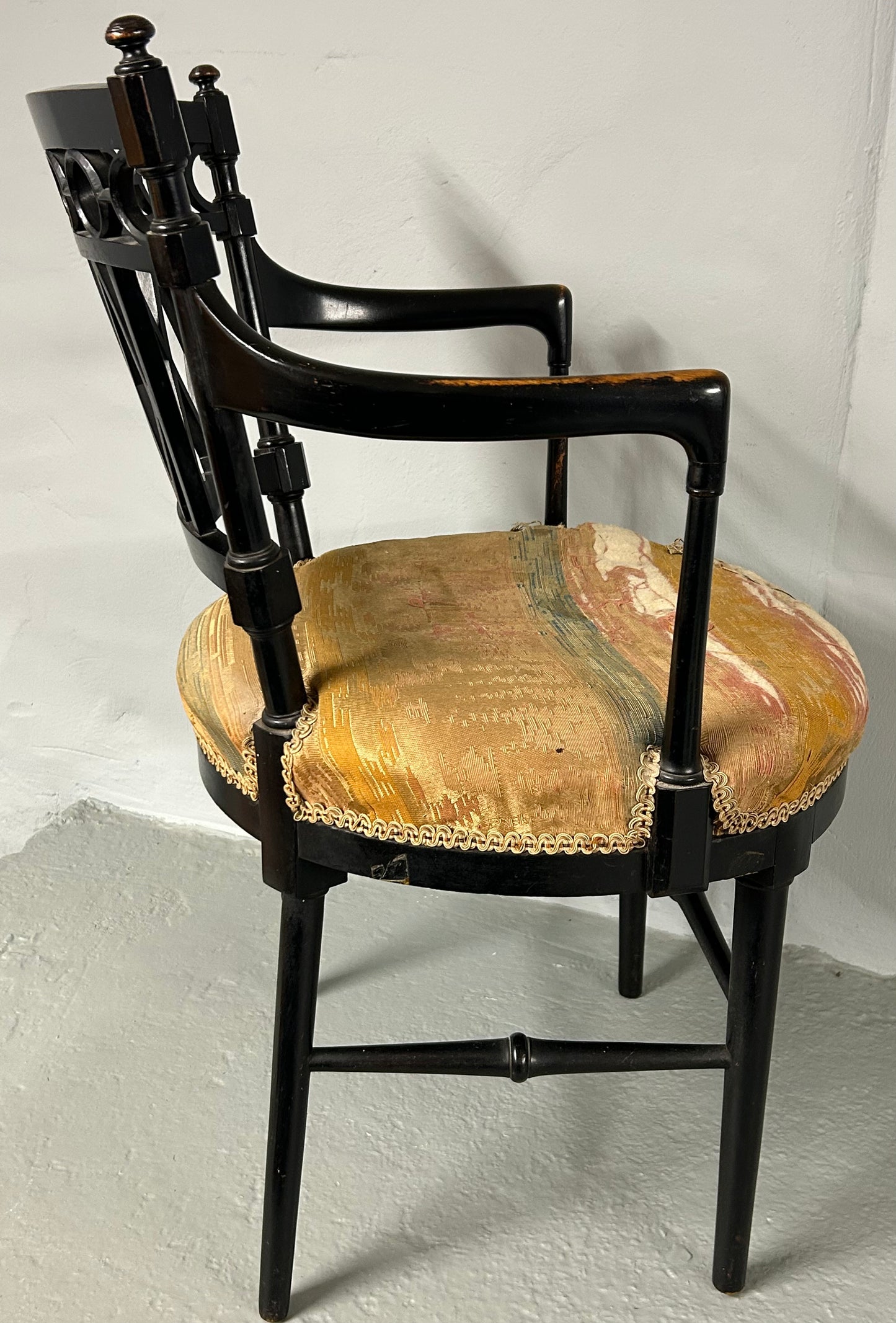 Collier and Plucknett ebonised aesthetic movement armchair.