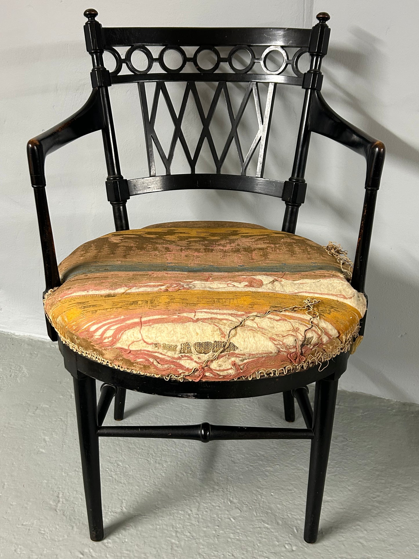 Collier and Plucknett ebonised aesthetic movement armchair.