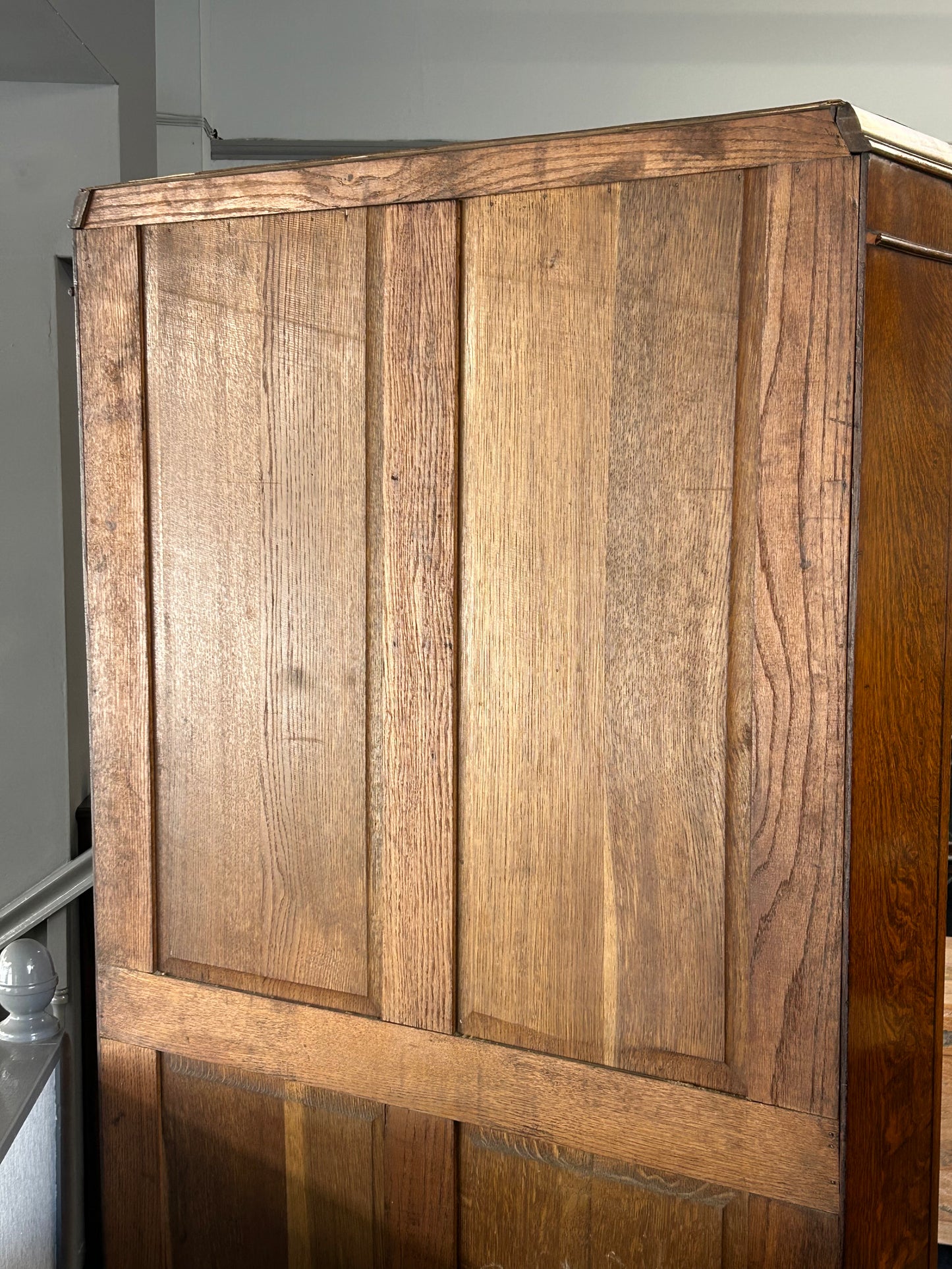 Solid oak 1920s hall robe with linen fold door